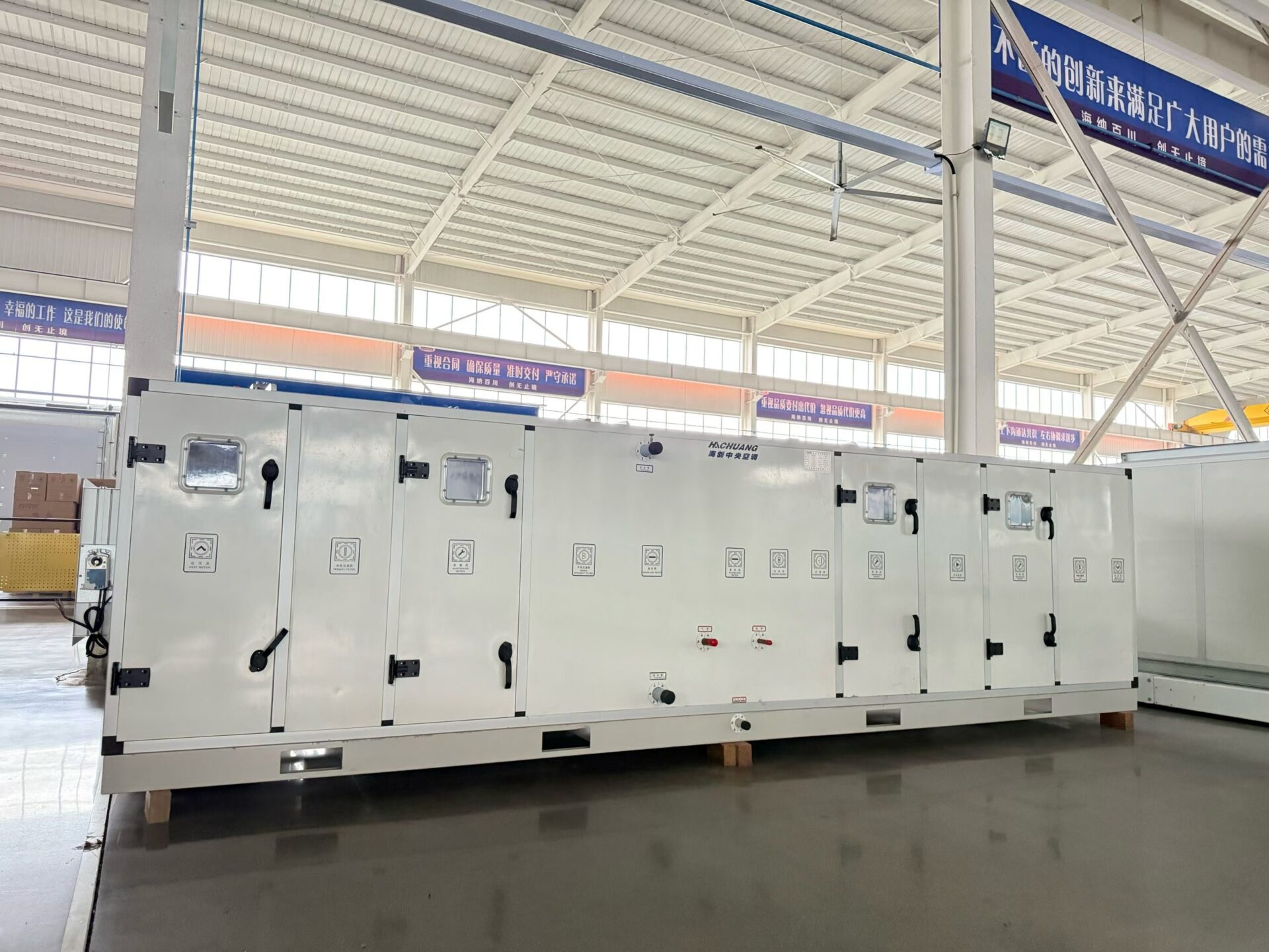Long assembled air handling unit with multiple service doors and visible casing-section joints